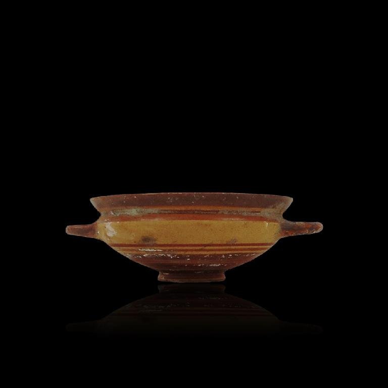 Ancient Greek Ionian cup: Ancient Greek Ionian cup, ca. 500 B.C. Two handled wine cup in excellent condition. 2-1/6" in height x 5-5/16" in diameter.