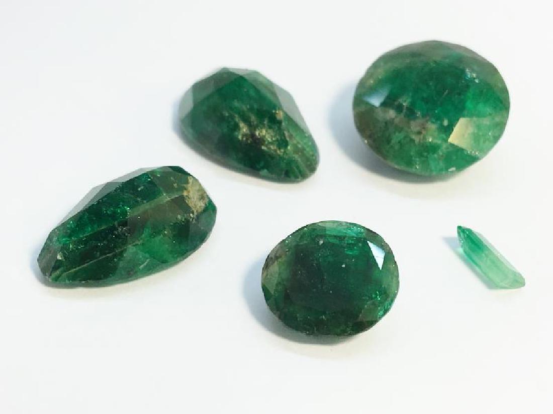 Five loose emeralds, one 8 ct round cut, one 3.1 ct (1 of 1)