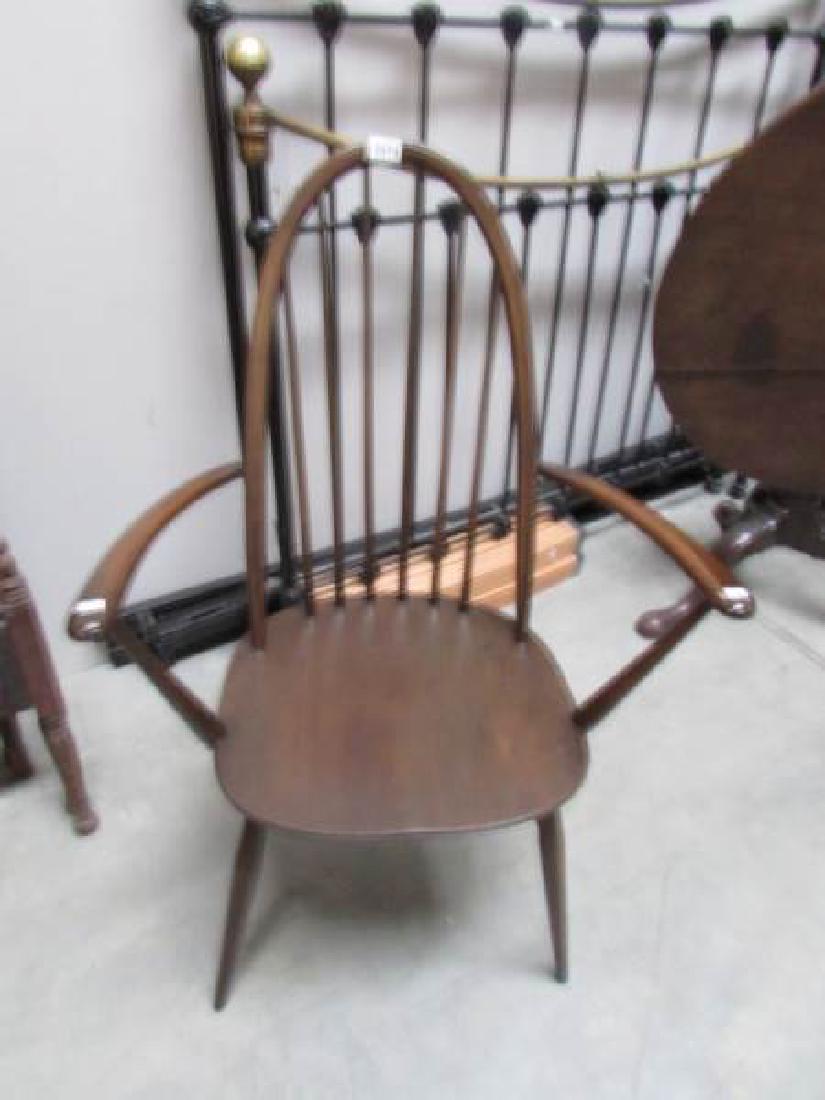 A dark Ercol elbow chair.: A dark Ercol elbow chair.