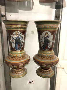 A pair of Mettlach vases with identical panels around: A pair of Mettlach vases with identical panels around vase of 2 girls. Each girl is signed by their artist (2 artists). Vases are well patterned in different colours and both have other markings under