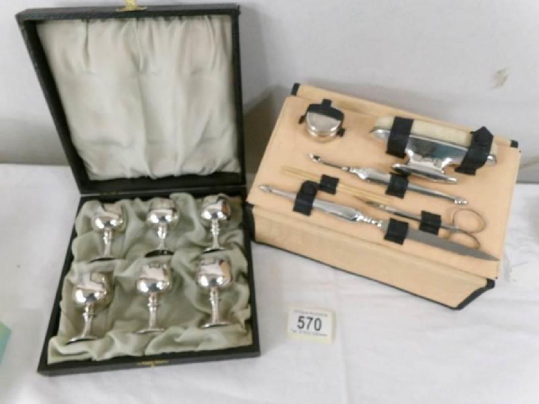 An art deco silver manicure set and a boxed set of 6: An art deco silver manicure set and a boxed set of 6 silver goblets.