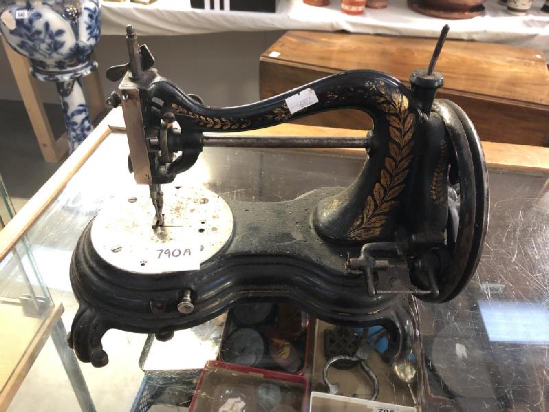An early Victorian hand cranked sewing machine.