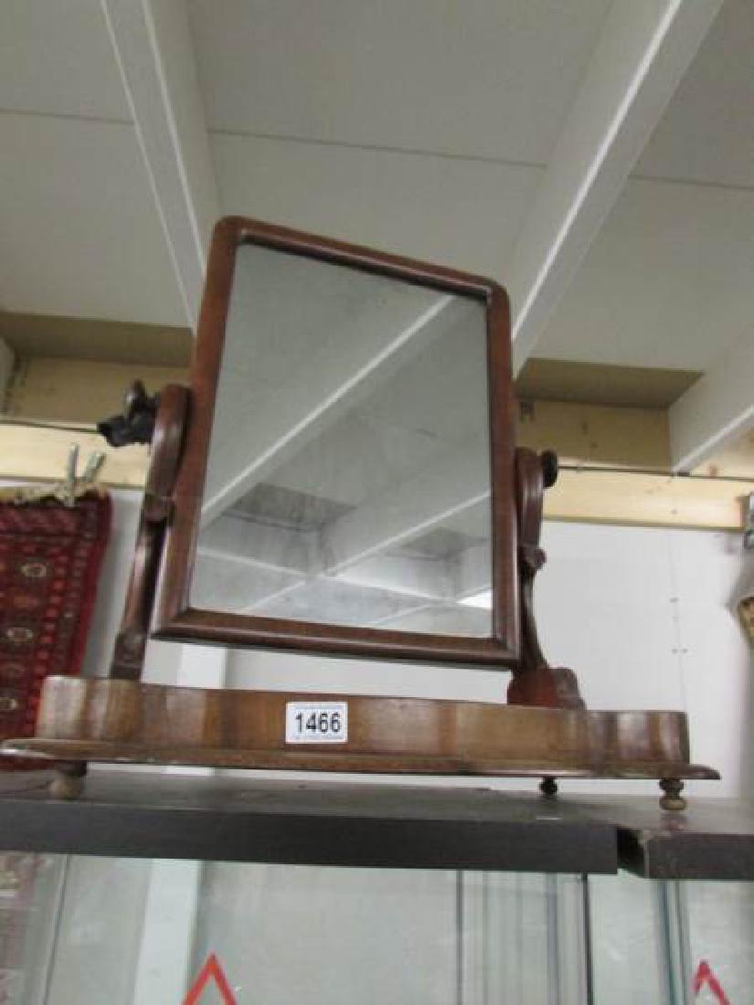 A Victorian mahogany toilet mirror.: A Victorian mahogany toilet mirror.