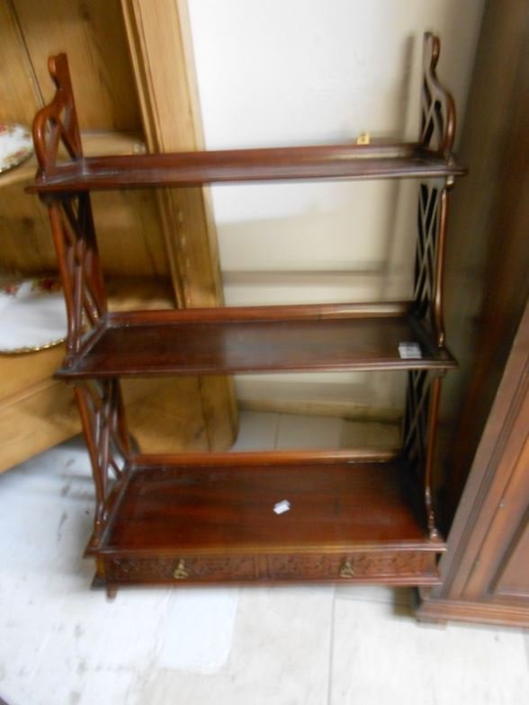 A mahogany wall hanging shelf with fretwork sides: A mahogany wall hanging shelf with fretwork sides