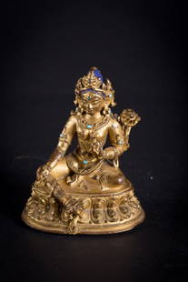 A figure of Green Tara: Nepal, circa 16th-17th Century A gilt copper cast with blue pigment in the hair of Green Tārā, ŚyāmaTārā (Sgrol-ljaṅ). Of pleasing form, the female figure sits in a