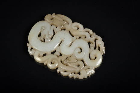 A jade intaglio: China, 20th Century Light coloured jade carving fretworked with archaistic dragon motifs. lxh 4,5 x 6,5 cm