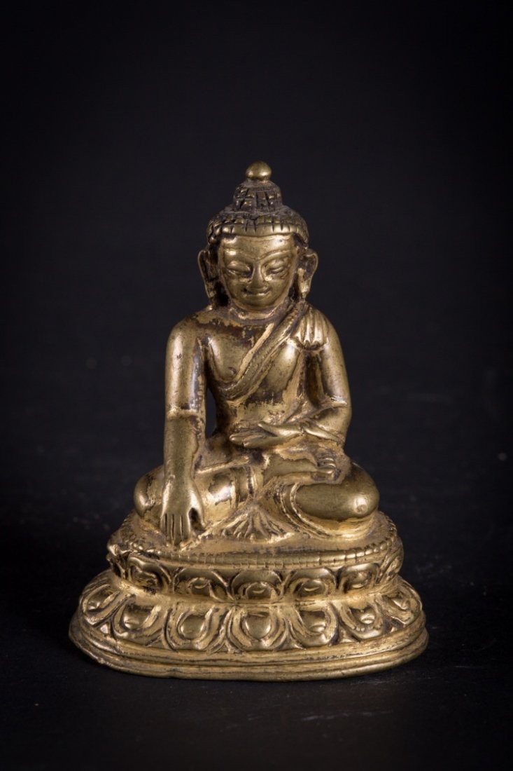 A figure of Sakyamuni: Nepal, circa 15th-16th Century With traces of gilding, a small light bronze representation of the Historical Buddha Śākyamuni (Śākya-thub-pa). Despite the small size there is fine 