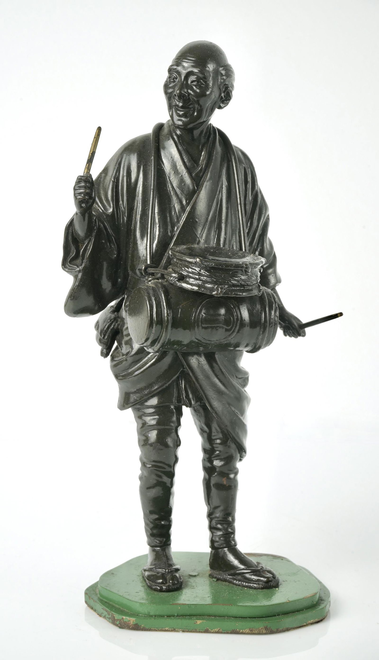 A Japanese bronze figure with mark, Meiji period.: A bronze figure depicting a man with musical instruments, with stamp seal, 22cm height. Provenance: Private collection of Mr. Steven Tyler.