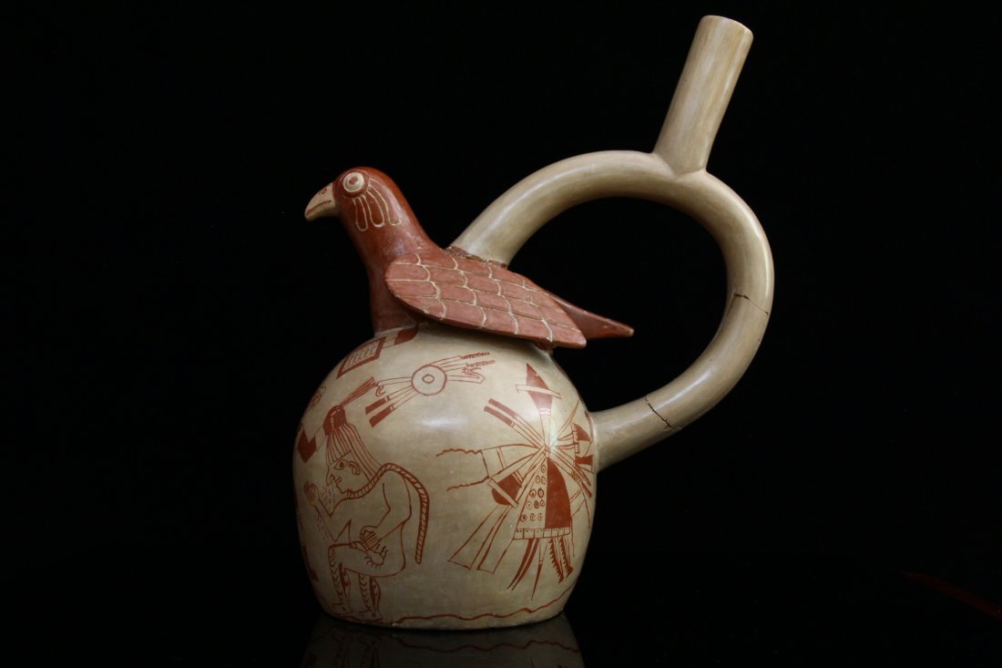 Pre Columbian Moche Fine-line Painted Vessel: Ancient Peru, Moche culture circa 200-700CE. Showcasing warriors, captured naked slaves and shields and war maces, all painted in fineline technique. A dove sits at top. Ocre and cream colours. Read c