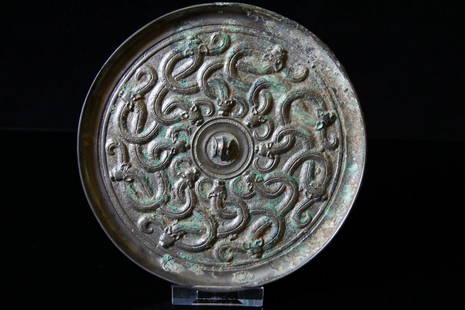 Chinese Bronze Mirror: Ancient China, Warring Stàtes Dynasty 480-221 BCE. A fantastic and well preserved bronze mirror with mythological intertwined serpents. D: 7inc (18cm). Property of a English gentleman, adquired late