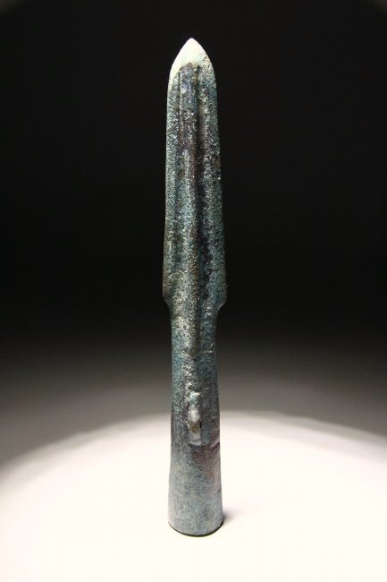 Chinese Warring States Period Spearhead: Ancient China, 475-403 BC. Bronze cast slender spearhead with tubular socket and narrow, parallel-sided blade with pierced loop. Lenght: 22cm or 8.5". Weight: 260 grams. Ex UK private collection forme