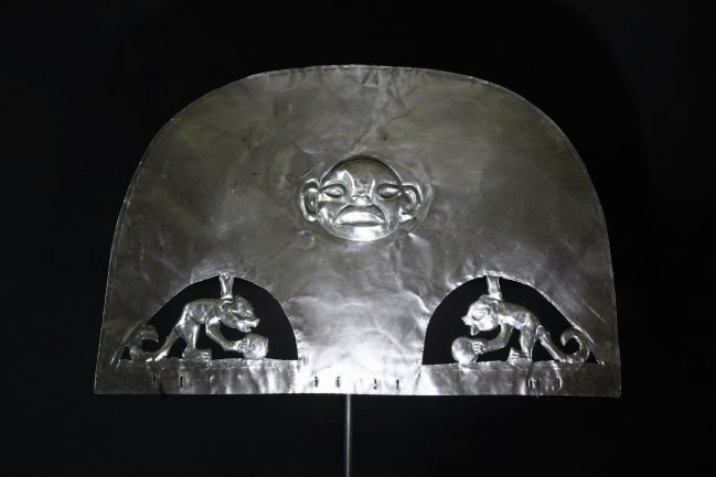Pre Columbian Moche Silver Headdress: Ancient Peru, 100-700 AD. A silver and copper alloy headdress with mythical beast and two mammals facing each other in repousse technique. Height: 22cm or 8.5". Length: 32 cm or 12.5". Weight: 103.2 g