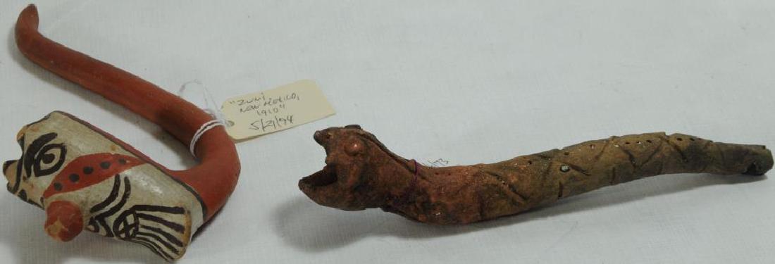 LOT OF 2 POTTERY PIPES TO INCLUDE POTTERY PIPE: WITH SNAKE EFFIGY, FROM S. MEXICO BELIEVED TO BE AZTEC, MEXICO. 6" ZUNI PIPE C. 1910, IN ORANGE, CREAM, AND BLACK. EFFIGY FACE BOWL; RED ON STEM, BACK OF BOWL, AND NOSE; WHITE/CREAM ON FRONT; BLACK EY