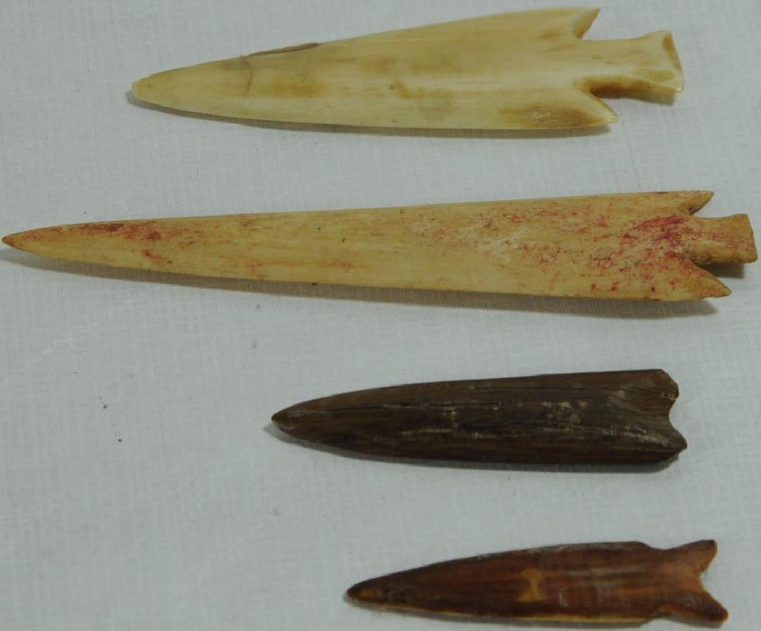 LOT OF 4 BONE/ANTLER PROJECTILE POINTS TO INCLUDE: ONE WITH RED PAINT/OCHRE TRACES, 4 1/4" L X 15/16" W, CORNER NOTCHED. ONE 3 1/4" L X 1" W, CORNER NOTCHED. ONE WITH CONCAVE BASE, 2 1/4" L X 5/8" W. ONE WITH CONCAVE BASE AND SIDE NOTCHED, 2" L X 1/2"
