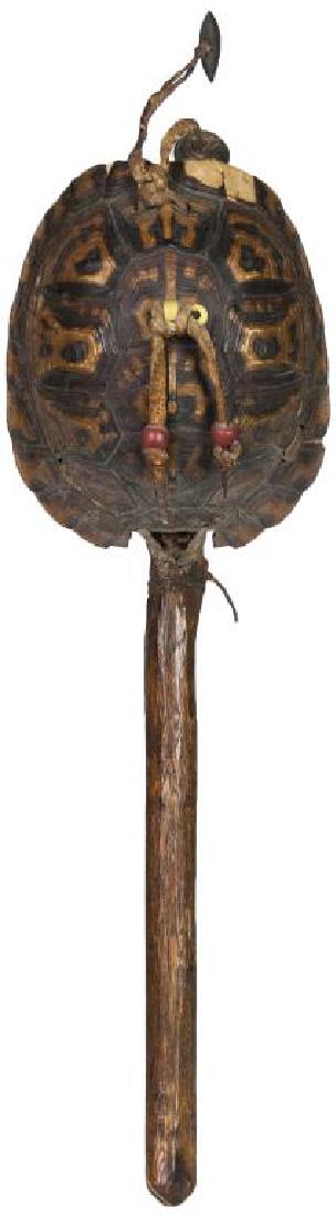 RARE EARLY TURTLE DANCE RATTLE, WITH LARGE RED: AND YELLOW TRADE BEADS AND TWO BRASS BELLS (ONE CRIMPED), CARVED WOOD HANDLE, 14” L, (EX. DR. OSCAR AND LOIS HOLLANDER COLLECTION, FALMOUTH, MA).