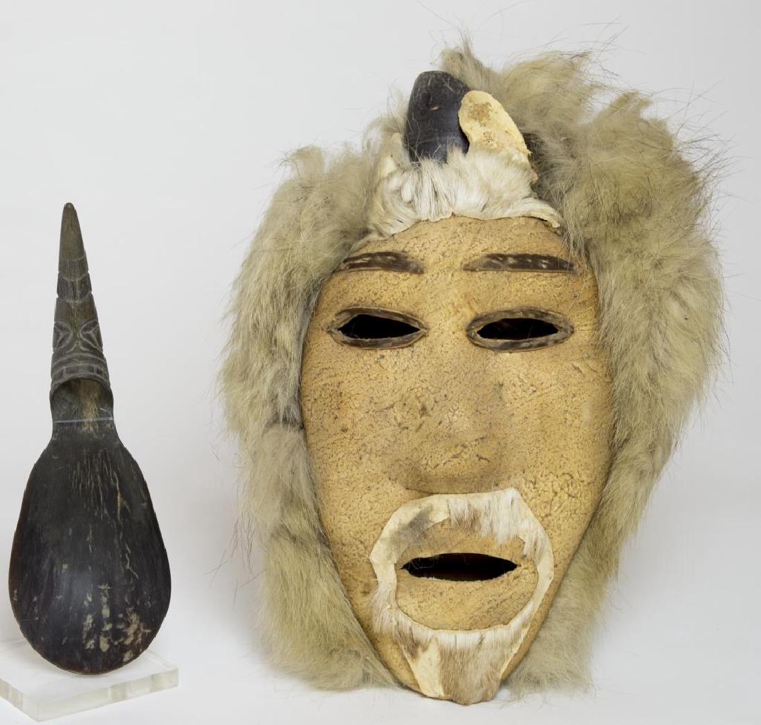 ESKIMO FACE MASK, SEAL SKIN, TRIMMED IN FUR,: SURMOUNTED BY A PARTIAL HOOF AND ANTLERS, SIGNED ON BACK “ELIJAH KAKINYA, ANAKUIURIK PASS, ALASKA”, 12” H; NORTHWEST COAST HORN SPOON WITH TOTEMIC CARVED HANDLE, GOOD CONDITION, 8 ¾” H.