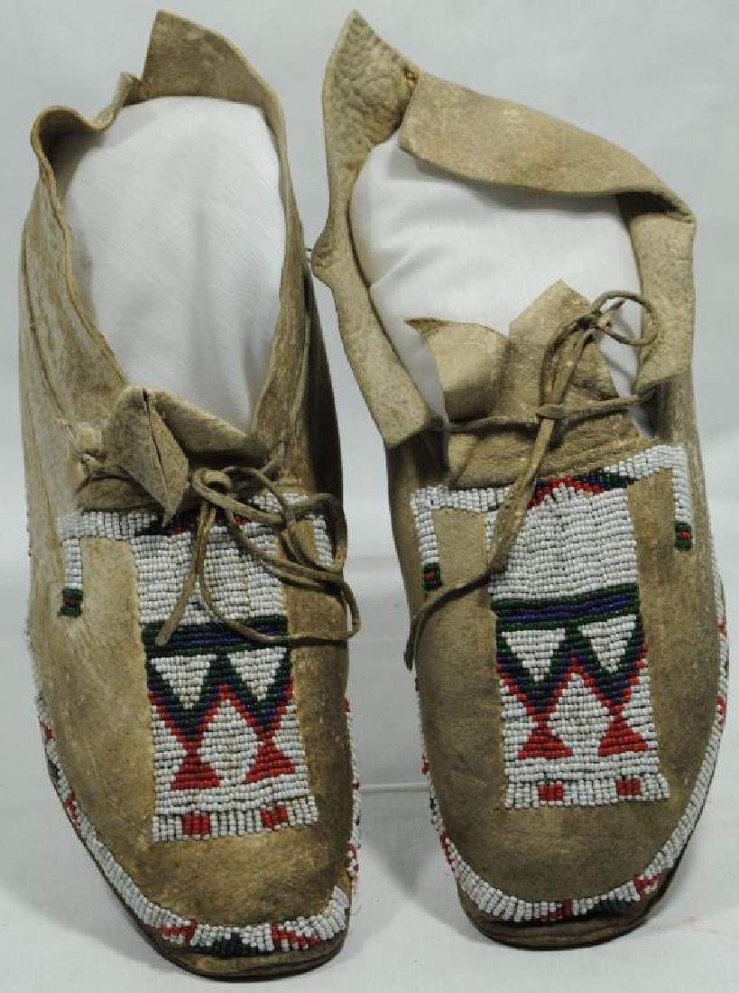 PAIR OF 20TH C. BEADED MOCCASINS WITH HUMAN: FIGURE DESIGNS, 9 1/2" L.