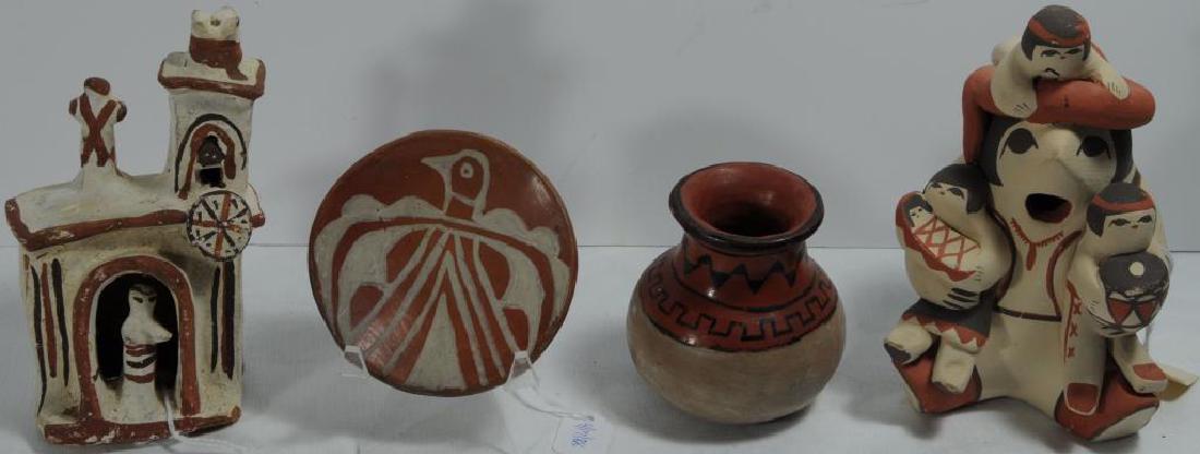 LOT OF 4 POTTERY PIECES TO INCLUDE A SMALL: POTTERY PLATE, 3 3/4" D, RED BACKGROUND, MOTIF: WHITE PAINTED THUNDERBIRD. SOUTHWEST. POTTERY BUILDING, CHURCH WITH CROSS, STEEPLE, AND BELL, PRIEST IN ENTRYWAY, PAINT: RED AND BROWN ON WHITE BACKGROU