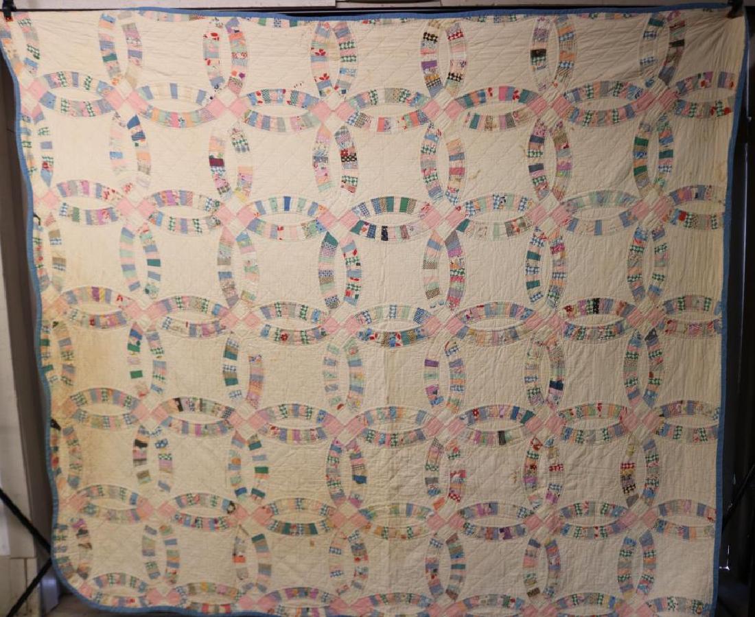 MID. 20TH C. WEDDING RING TYPE HAND SEWN QUILT,: SHOWS SOME DAMAGE AND STAINING, 87" X 78"