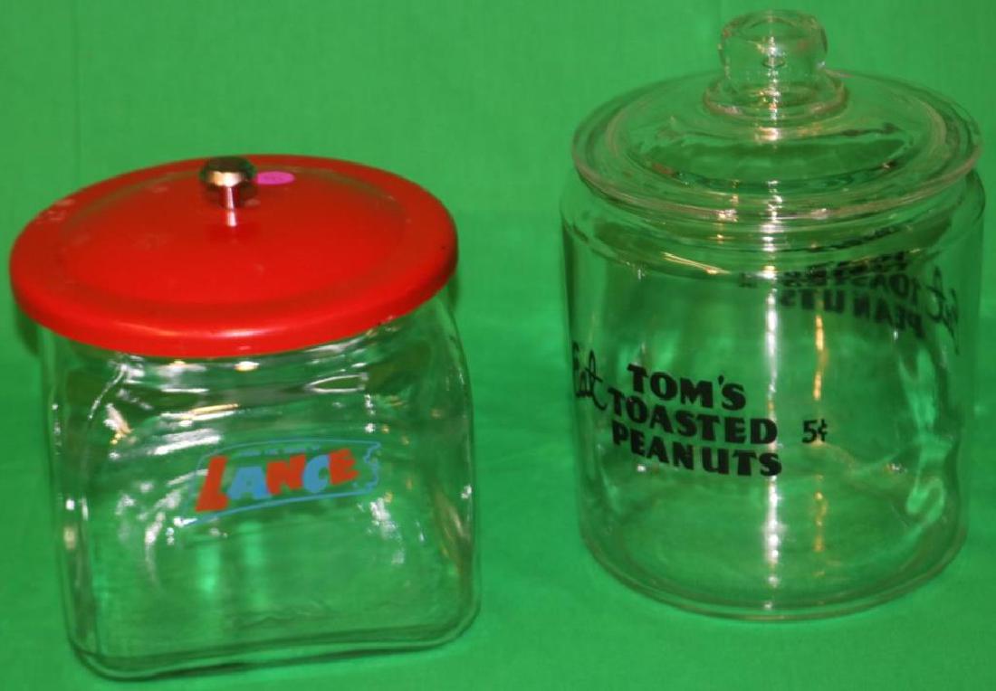 2 GLASS NUT JARS INCL TOM'S TOASTED PEANUTS 5: CENTS WITH GLASS TOP, 10" H X 7" DIA. & LANCE WITH METAL TOP, 8" H X 7" X 7"