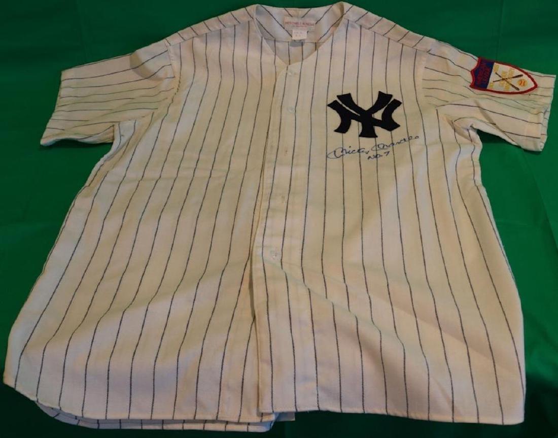 MICKEY MANTLE SIGNED AUTHENTIC MITCHELL AND NESS: JERSEY, SIGNED ON FRONT MICKEY MANTLE #7. HAS A GOLDEN ANNIVERSARY PATCH, UNWORN CONDITION.