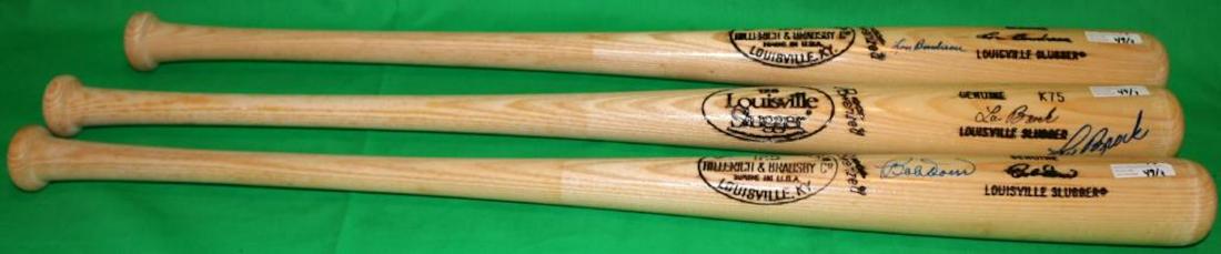LOT OF 3 HALL OF FAME BATS ALL LOUISVILLE: SLUGGERS #125 TO INCLUDE ONE SIGNED LOU BOUDREAU, 33 1/2" LONG, KNOB MARKED TM K55. THE OTHER IS SIGNED LOU BROCK, K77, 34 3/4" LONG. THE 3RD IS SIGNED BOBBY DOERR, 34 1/2" LONG.