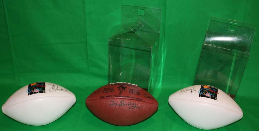 LOT OF 3 AUTOGRAPHED WILSON FOOTBALLS, NATIONAL: FOOTBALL LEAGUE. ONE IS SIGNED BY TOM LANDRY, THE OTHER IS SIGNED STEVE BEUERLEIN AND THE 3RD JEFF HOSTETLER. TWO HAVE ORIGINAL BOXES.
