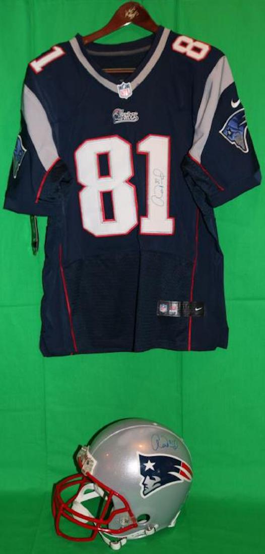 SIGNED AARON HERNANDEZ HELMET AND SHIRT. THE: JERSEY DISPLAYS #81 AND IS SIGNED ON THE #1, NIKE NFL GEAR. THE HELMET IS BY RIDDELL AND SIGNED ON TOP. SHOWS SCUFF MARK.