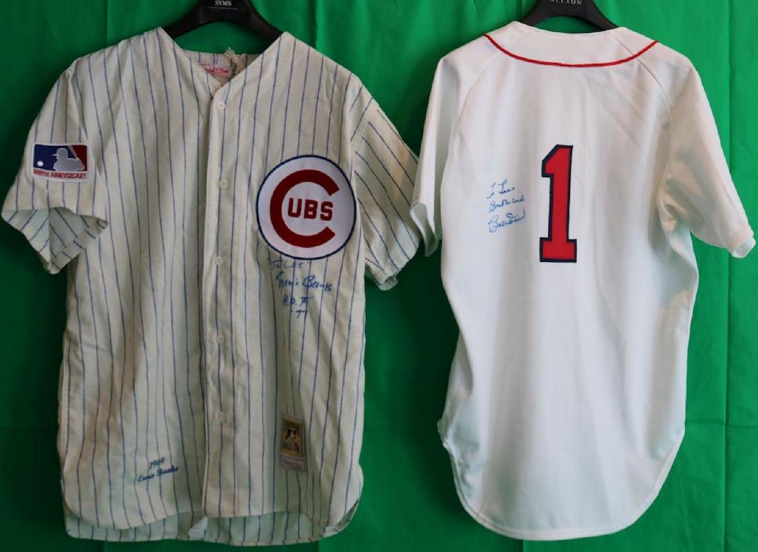 2 HALL OF FAME JERSEYS . ONE IS MITCHELL & NESS.: THE OTHER IS RAWLINGS TO INCLUDE A JERSEYS SIGNED BY ERNIE BANKS, CHICAGO CUBS #14, SIZE 48, X LARGE. AND A SIGNED BOBBY DOERR, BOSTON RED SOX #1, WITH DEDICATION, SIZE 44.