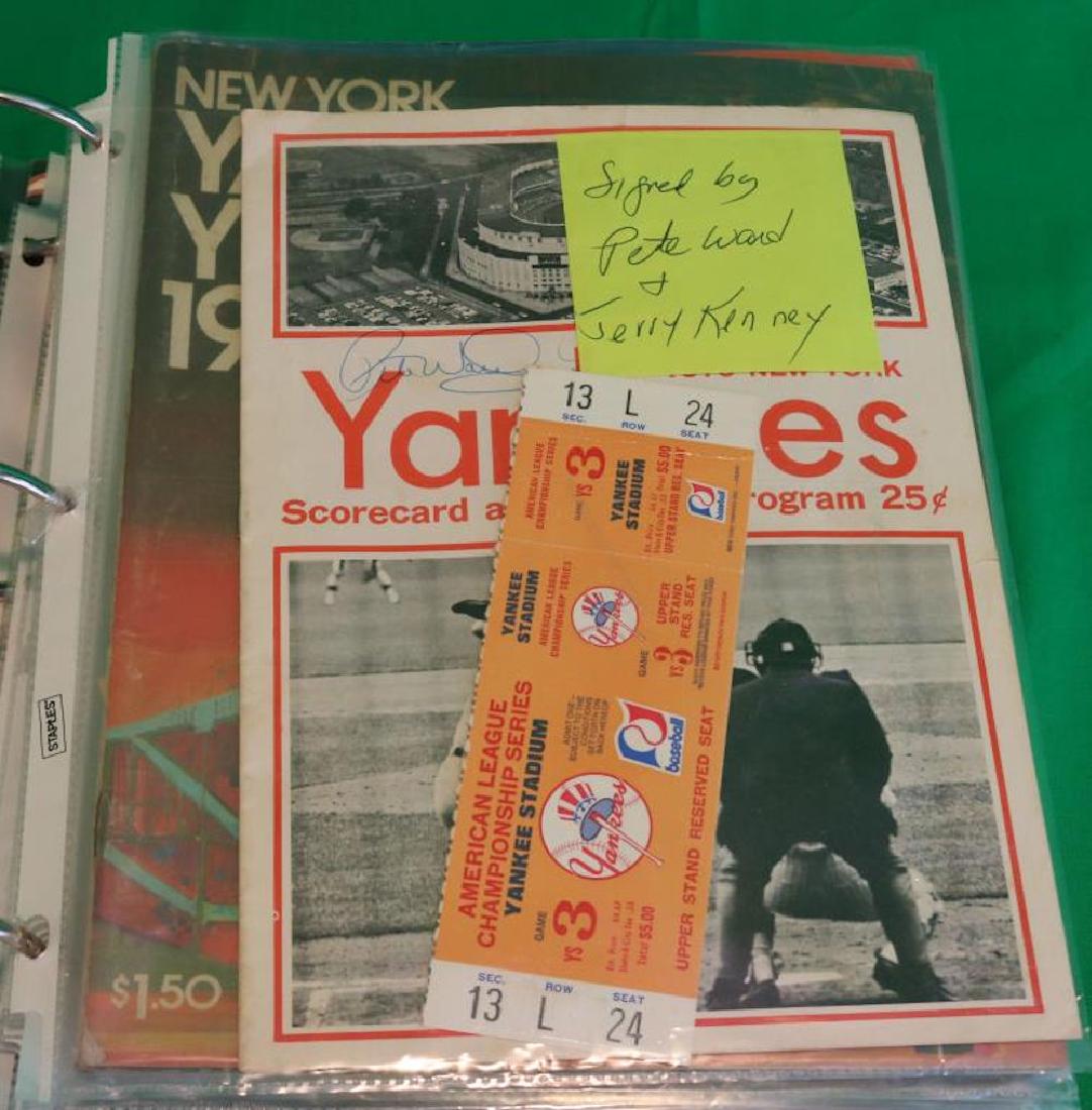 BINDER CONTAINING 14 PIECES OF EPHEMERA TO: INCLUDE YANKEES YEARBOOKS FROM 1970'S, 80'S AND AN AMERICAN CHAMPIONSHIP SERIES TICKET 1970. 11 1/2" X 11 1/2".