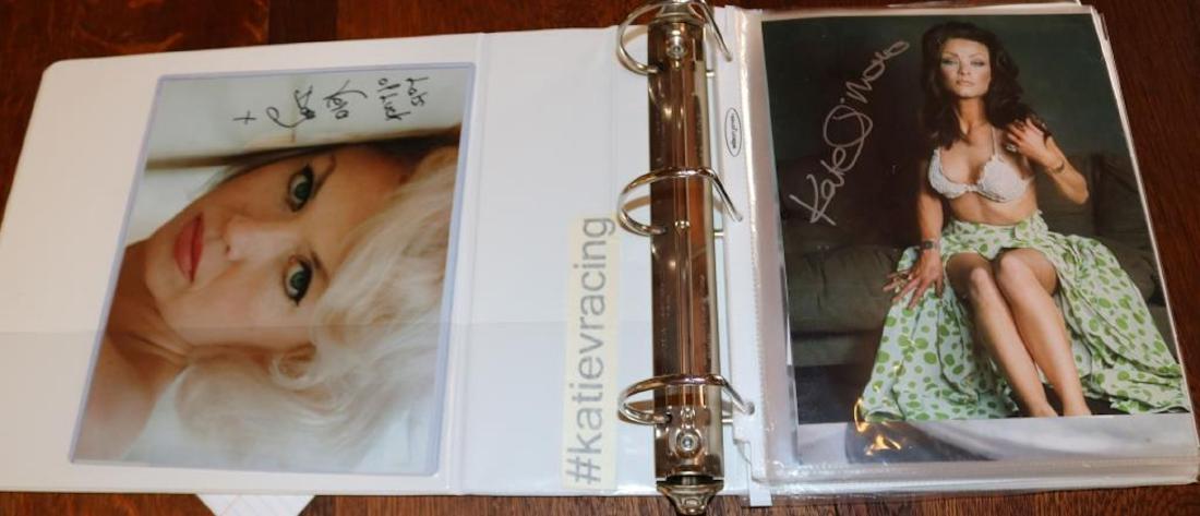 BINDER CONTAINING 37 PIECES OF PROMOTIONAL: EPHEMERA TO INCLUDE SIGNED PHOTOS BY JULIE CLARK, VERA DAY, VERONICA CARLSON, KATE SMITH OF CHARLIES ANGELS, INGRID PITT, LOIS CHILES, ROGER MOORE AND OTHERS. 11 1/2" X 11 1/2".