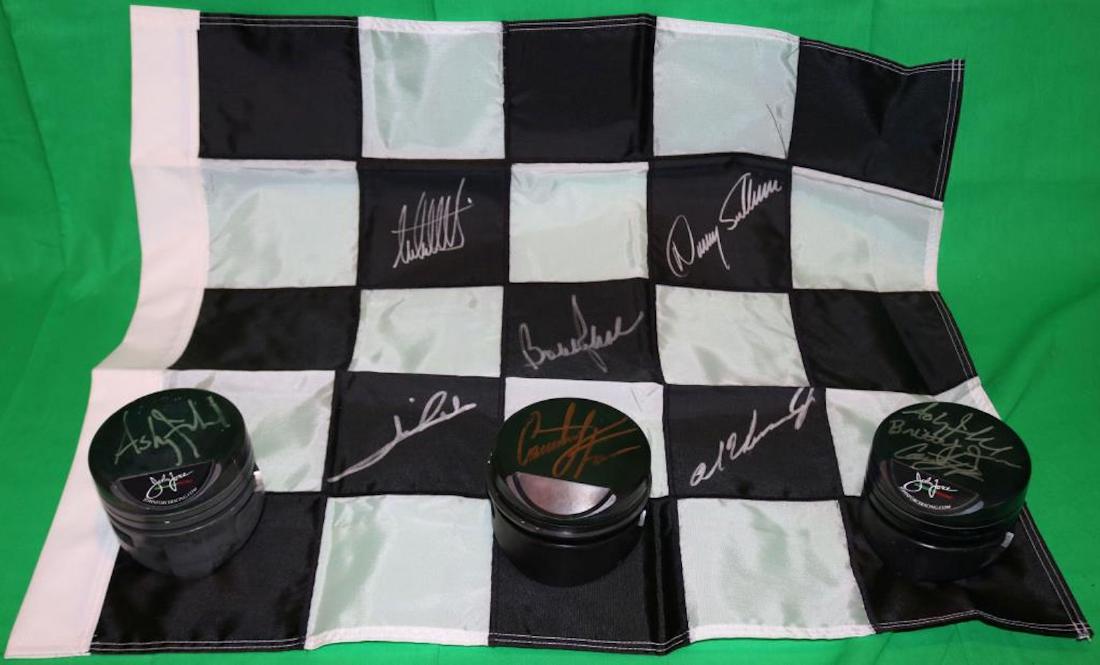 NASCAR LOT WITH 3 JOHN FORCE RACING PISTONS ALSO: SIGNED BY 3 RACING TEAM MEMBERS. 3 1/8" HIGH X 4 1/16" D. ALONG WITH A NASCAR BLACK AND WHITE CHECKERED FLAG SIGNED BY AL UNSER, JR., DANNY SULLIVAN AND OTHERS.