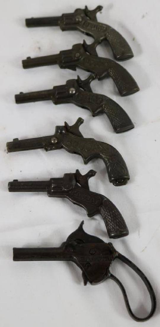 COLLECTION OF 6 SMALL CAST IRON CAP GUNS, 4 BY: PLUCK, 1 COWBOY AND 1 HOT SPUR, 3 3/4" - 4 1/4" L