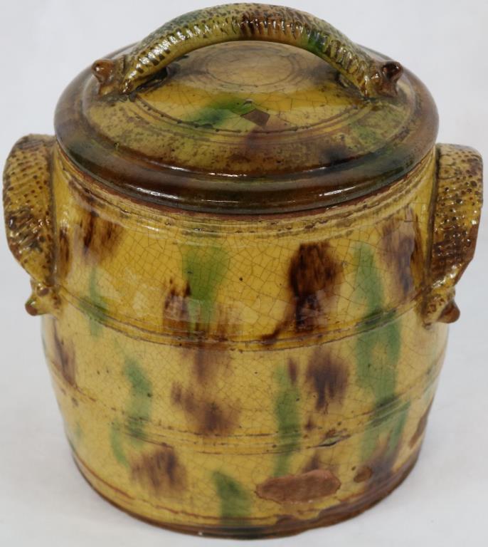 EARLY 19TH C. REDWARE HANDLED COVERED CROCK WITH: IMPRESSED HANDLED BARREL SHAPED, SHOWS GLAZE MISSING, 8" H, 7 1/2" W, 6 1/4" DIA.