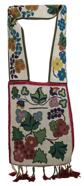 OJIBWA CEREMONIAL BANDOLIER BAG, FLORAL DESIGNS: ON WHITE BACKGROUND, COBALT, ROSE, GREENS, YELLOW, RED SILK BORDER, OVERALL GOOD CONDITION, VERY MINOR BEAD LOSS, LARGE GREEN TRADE BEAD DROPS WITH RED WOOL TASSELS, 14 1/2" W, 16" L, 40" OVERALL L.
