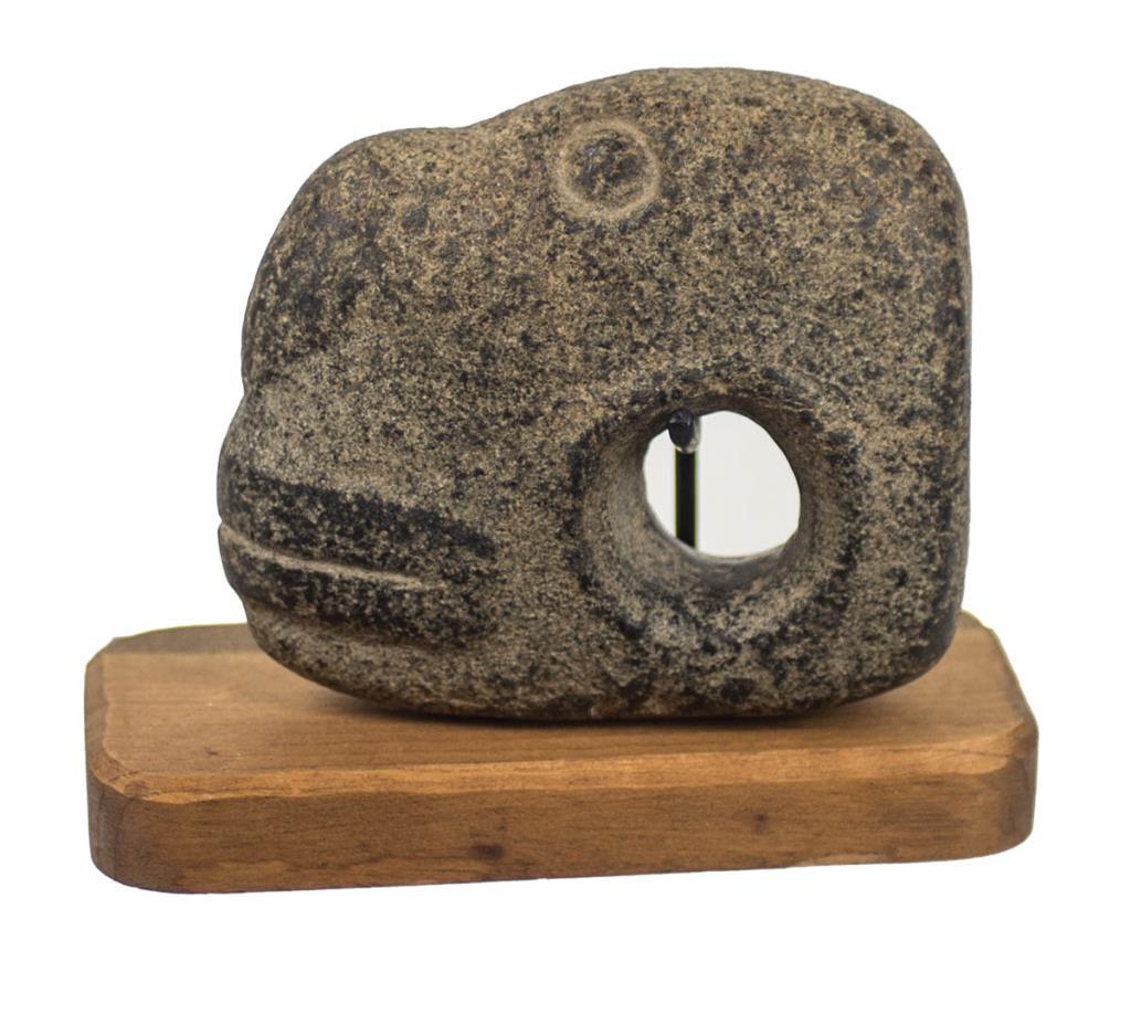 PREHISTORIC NORTHWEST COAST STONE FIGURAL AXE: HEAD, "SLAVE KILLER", CARVED EYES AND LIPS, MOUNTED ON A CARVED WOOD BASE, 4 1/2" H, 5" L.