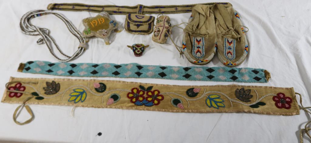LOT OF EARLY 20TH C. NATIVE AMERICAN BEAD WORK, 8: ITEMS TO INCLUDE 29 1/2" X 3" FLORAL BELT, 26 1/2" X 2" STRIP, PAIR OF MOCCASINS, 10" X 4", 4 1/4" BAG, 25" X 1 1/2" BELT WITH MATCHING BAG 5 1/2" X 3 1/2", 4 1/2" STAR SHAPED PIN CUSHION DATED 1919, 
