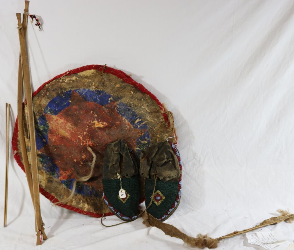 LOT OF MISC. NATIVE AMERICAN ITEMS TO INCLUDE: BEADED MOCCASINS WITH STIFF LEATHER, 9 1/2" L, PAINTED HIDE SHIELD MISSHAPEN, 19 1/2" DIA., 2 CHILDS WOODEN BOW & ARROWS, APPROX. 26 1/2" W
