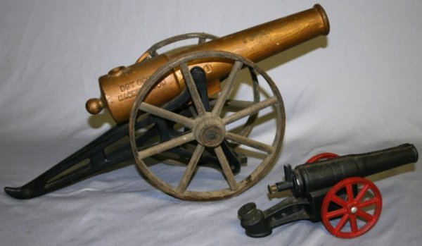 TWO TOY CANNONS: ONE MARKED "BOY SCOUT MACHINE GUN", OTHER IS CAST IRON UNMARKED, 19" & 9" L.