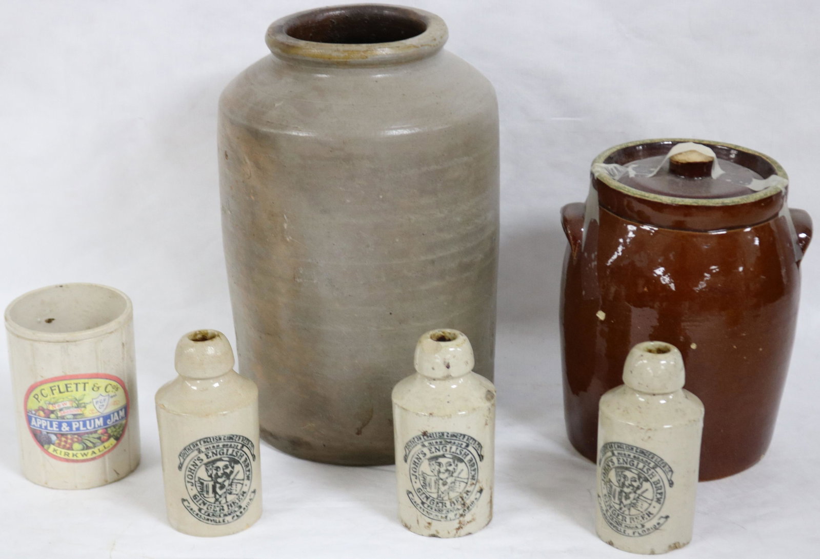 6 PCS. STONEWARE TO INCLUDE THREE 6" GINGER: BEERS, 5 1/4" FRUIT JAR, 9" POSSIBLE COOKIE JAR, 13" STORAGE JAR