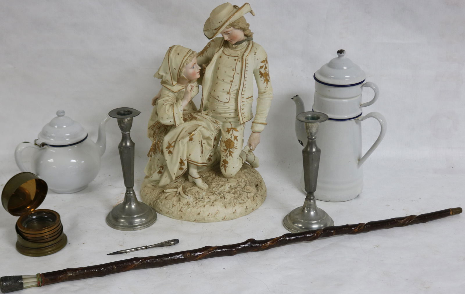 8 PC. LOT TO INCLUDE LARGE PORCELAIN FIGURAL: GROUP, HAT REPAIRED, 15 1/2" H, WHIT ENAMEL TEA & COFFEE POT, 8 1/2" H PEWTER CANDLESTICKS, 33" WALKING STICK, BRASS BOX WITH COASTERS, 5" OWL WITH STERLING HANDLE