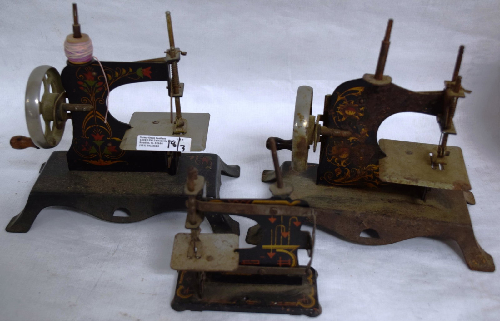 THREE PETITE CHILDREN'S SEWING MACHINES WITH: PAINTED DECORATION - ONE WITH ROUGHAGE TO SURFACE 5" - 7" H X 4.25 - 8" W