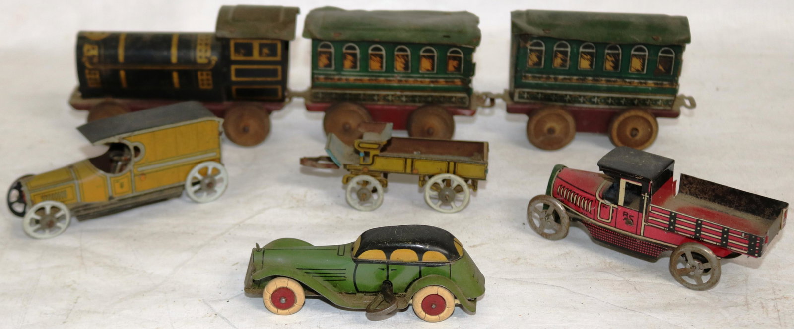 COLLECTION OF 7 EARLY LITHO TIN TOYS TO INCL.: LINDSTROM 4 WIND UP CAR 4.12" TIN TRUCK, 4" VAN WITH DRIVER, 3.12"WAGON, 3 PCS TRAIN SET MISSING SMOKE STACK