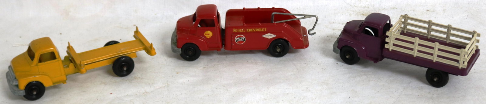 LOT OF 3 STRUCTO DIE CAST TRUCKS TO INCL. RACK: BODY, WRECKER AND A LOG TRUCK - EXCELLENT OVERALL CONDITION APPROX 6" L