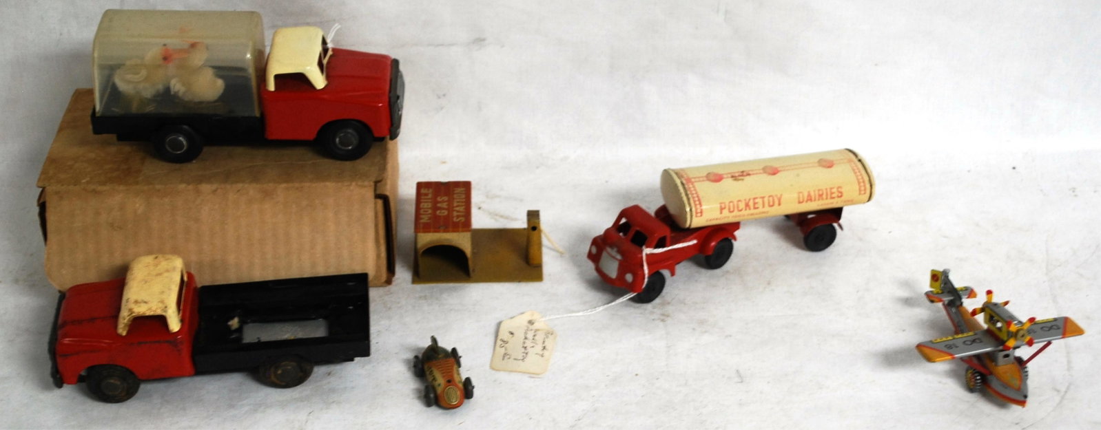 5 EARLY TIN TOYS: MOBILE GAS STATION WITH JET: CAR, DORNIER 18 TIN PLANE, POCKETOY DAIRIES TANKER TRUCK, RED TRUCK (CHINA), & CHICKEN TRUCK (CHINA)