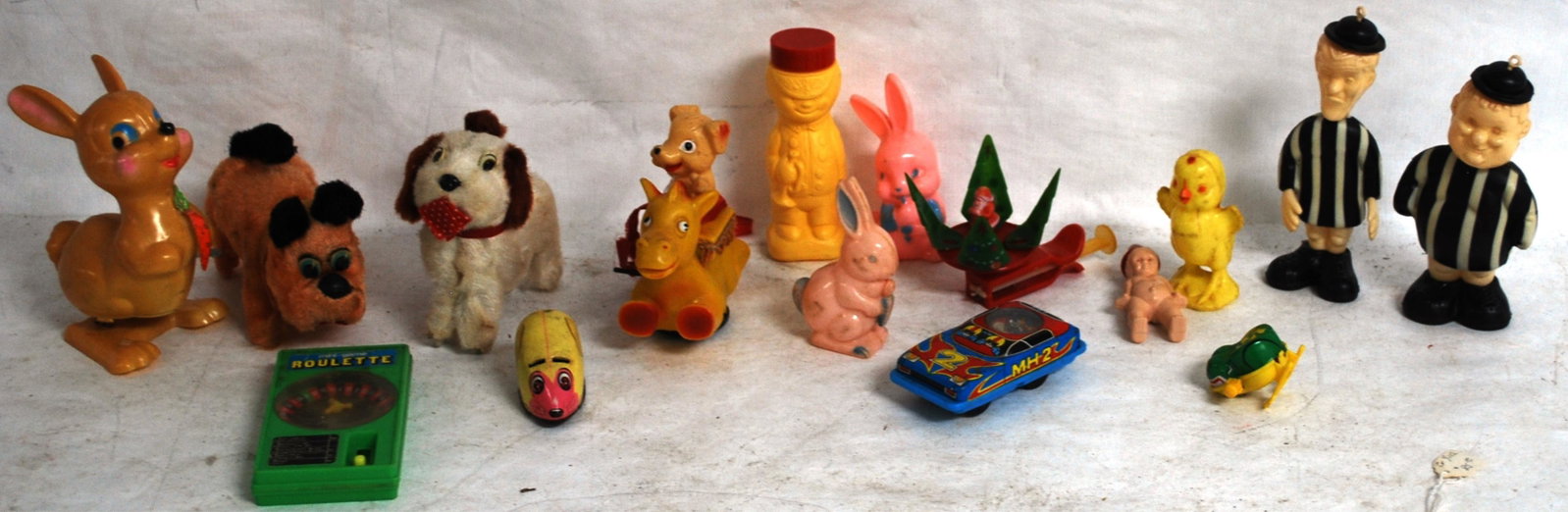 14 DIME STORE, MOVERS AND WIND UP TOYS INCL. BEAR: ON CAMEL, INMATES, MOUSE, FROG, MADE IN JAPAN DOGS, JIMMY TOY CAR, EASTER BUNNY, RATTLES, CHRISTMAS &ROULETTE