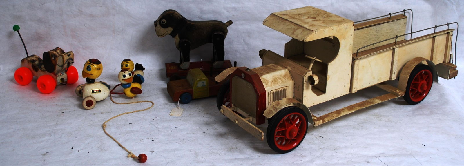 WOODEN MODEL TRUCK 27" L X 10" H X 8.5" W & FOUR: WOOD PULL TOYS: FISHER PRICE "LITTLE SNOOPY", BRIO DUCKS, FRANTZ BOSTON TERRIER, & TIN CAB CHOICE
