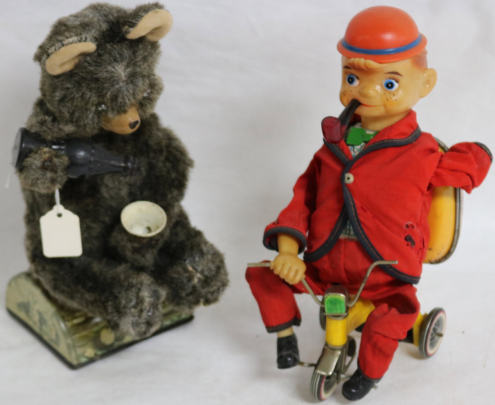 BATTERY OPERATED DRINKING BEAR, BATTERY BOX SHOWS: RUST, TOGETHER WITH PIPE SMOKING BOY ON TRICYCLE, BATTERY OPERATED, BATTERY BOX SHOWS RUST, APPROX. 10" H, BOY MISSING HAND, CLOTHING SHOWS TEARS