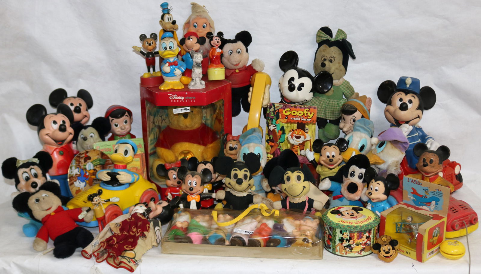 LARGE COLLECTION OF 44 DISNEY FIGURES TO INCLUDE: MICKEY & MINNIE, DONALD, GOOFY, PINOCCHIO, 7 DWARVES, WINNIE THE POOH, INCLUDING PULL TOYS, PLUSH, ETC.