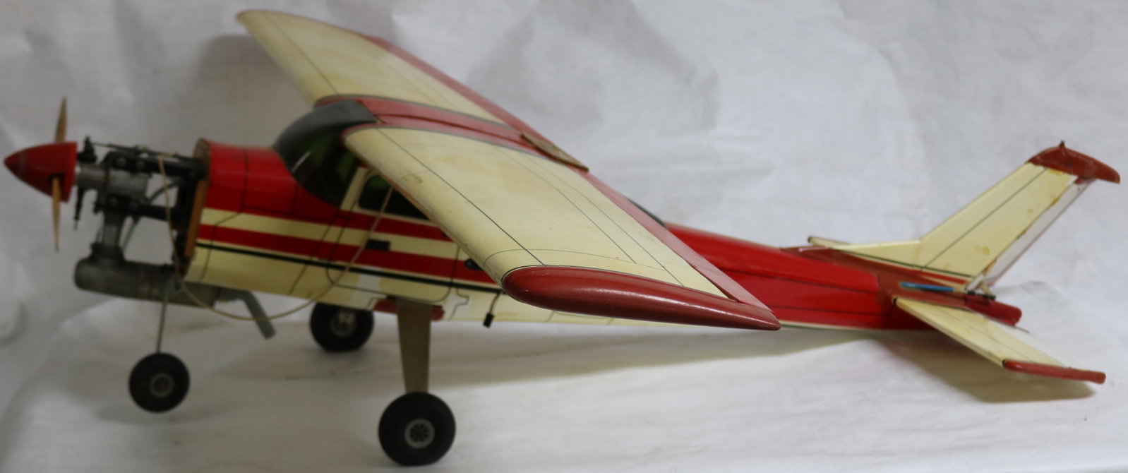 LARGE MODEL AIRPLANE, RED & WHITE, UNKNOWN: WORKING CONDITION, 48" L, 61 1/2" WINGSPAN, APPROX. 12 1/2" H
